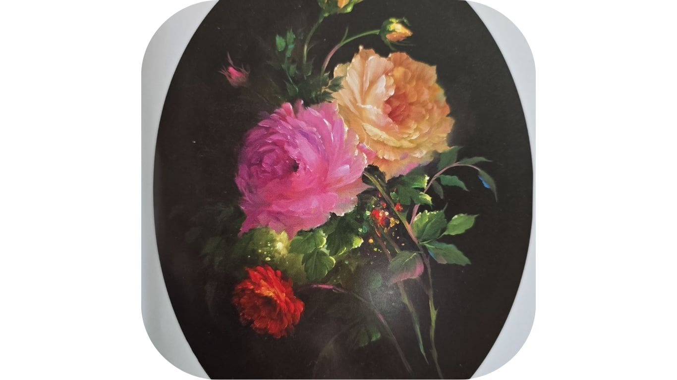 A bouquet of colorful roses in a dark oval frame.