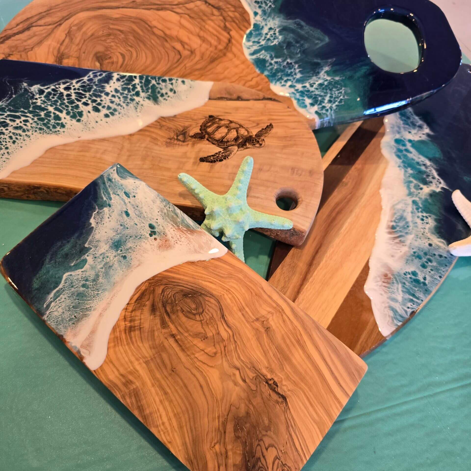 Wooden boards with ocean-themed resin art.