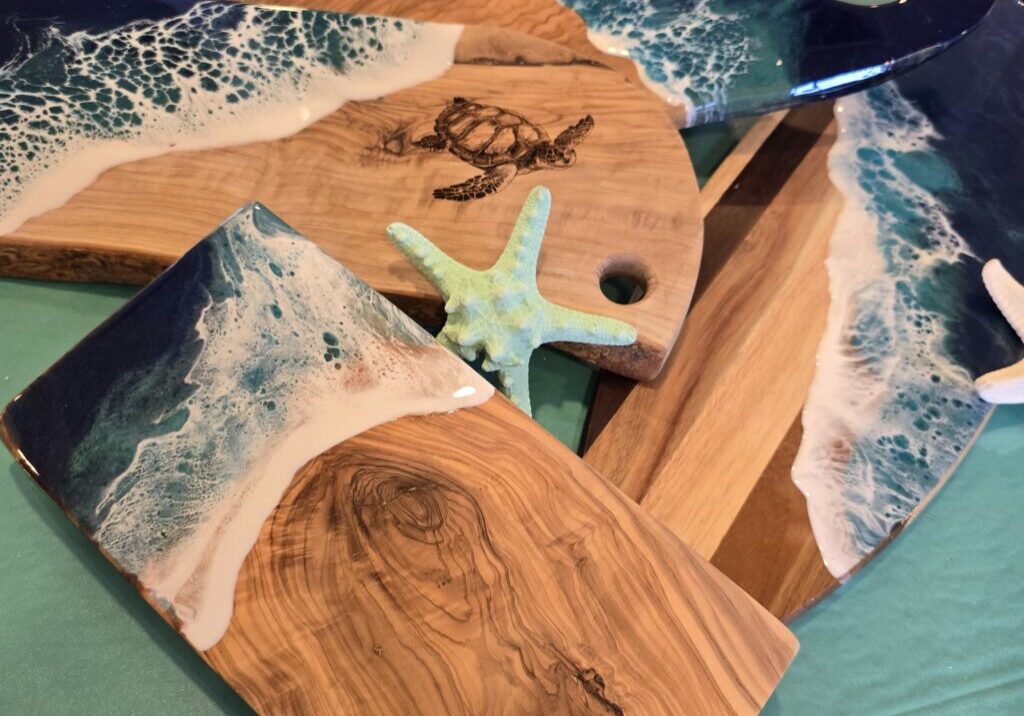 Wooden boards with ocean-themed resin art.